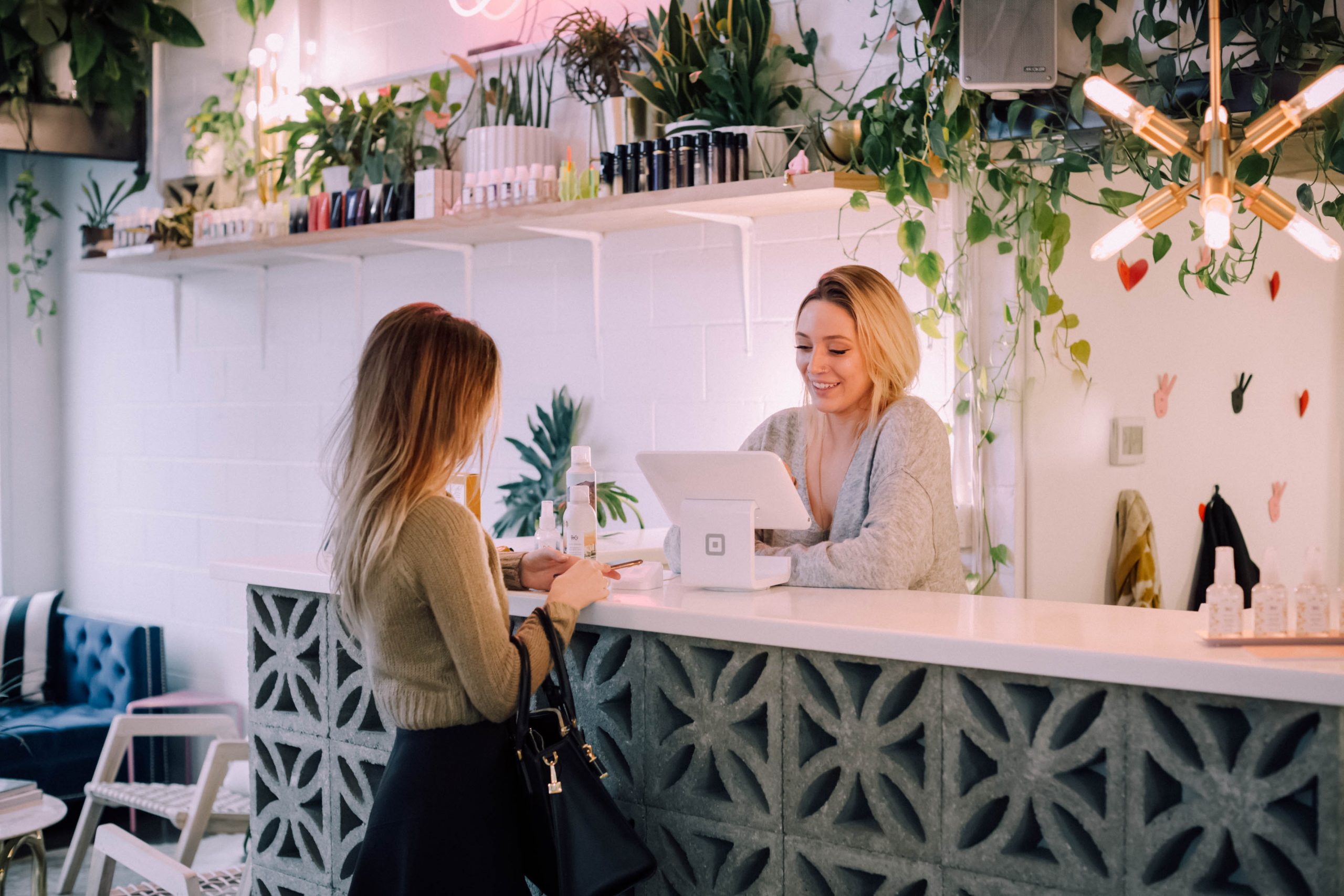 Two women at a checkout showing a great example of customer-first approach to business